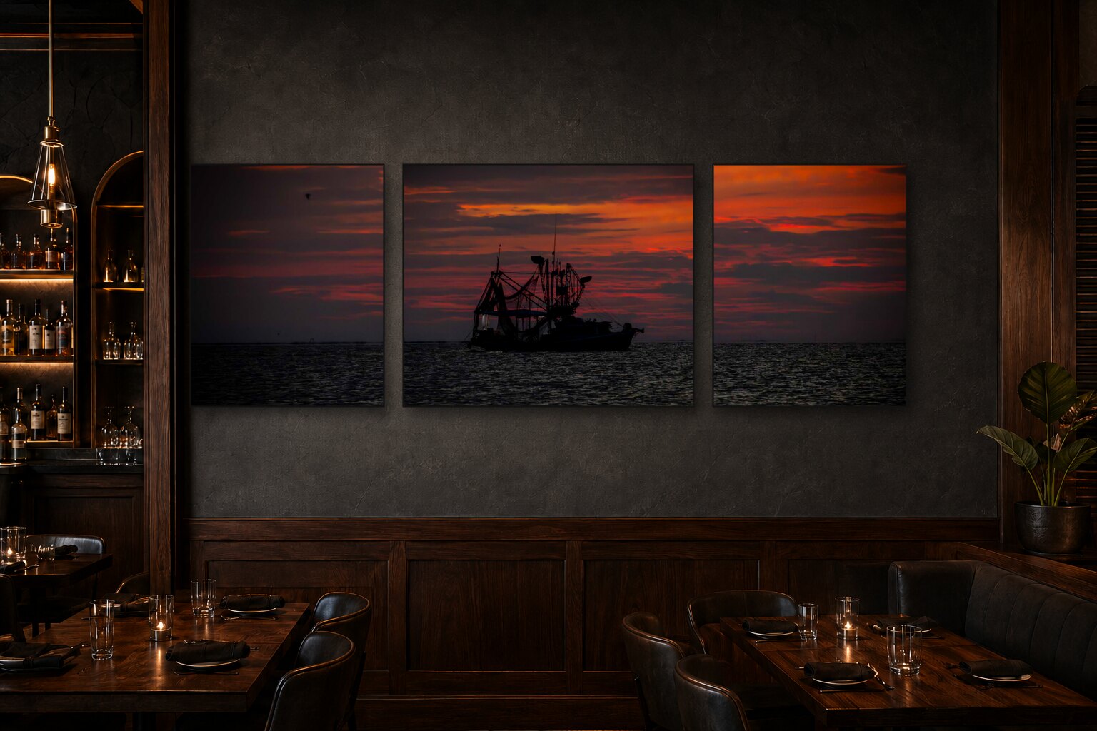 Shrimp and Sunsets triptych displayed in a dark restaurant interior