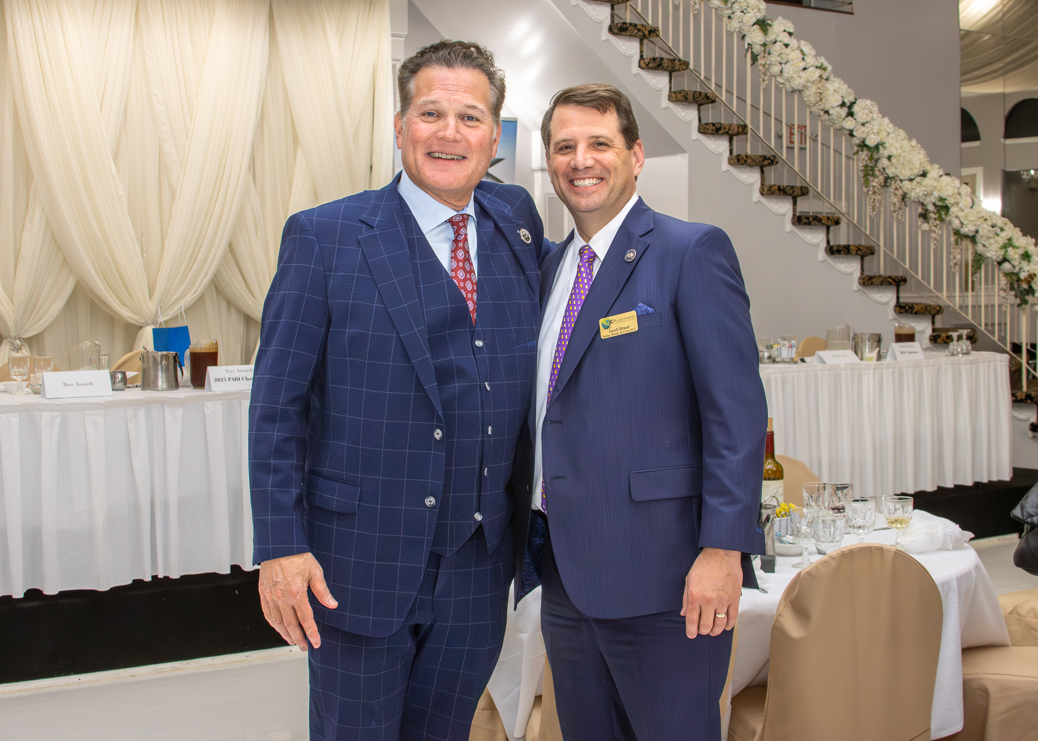 Two Louisiana business and civic leaders photographed together at a formal event
