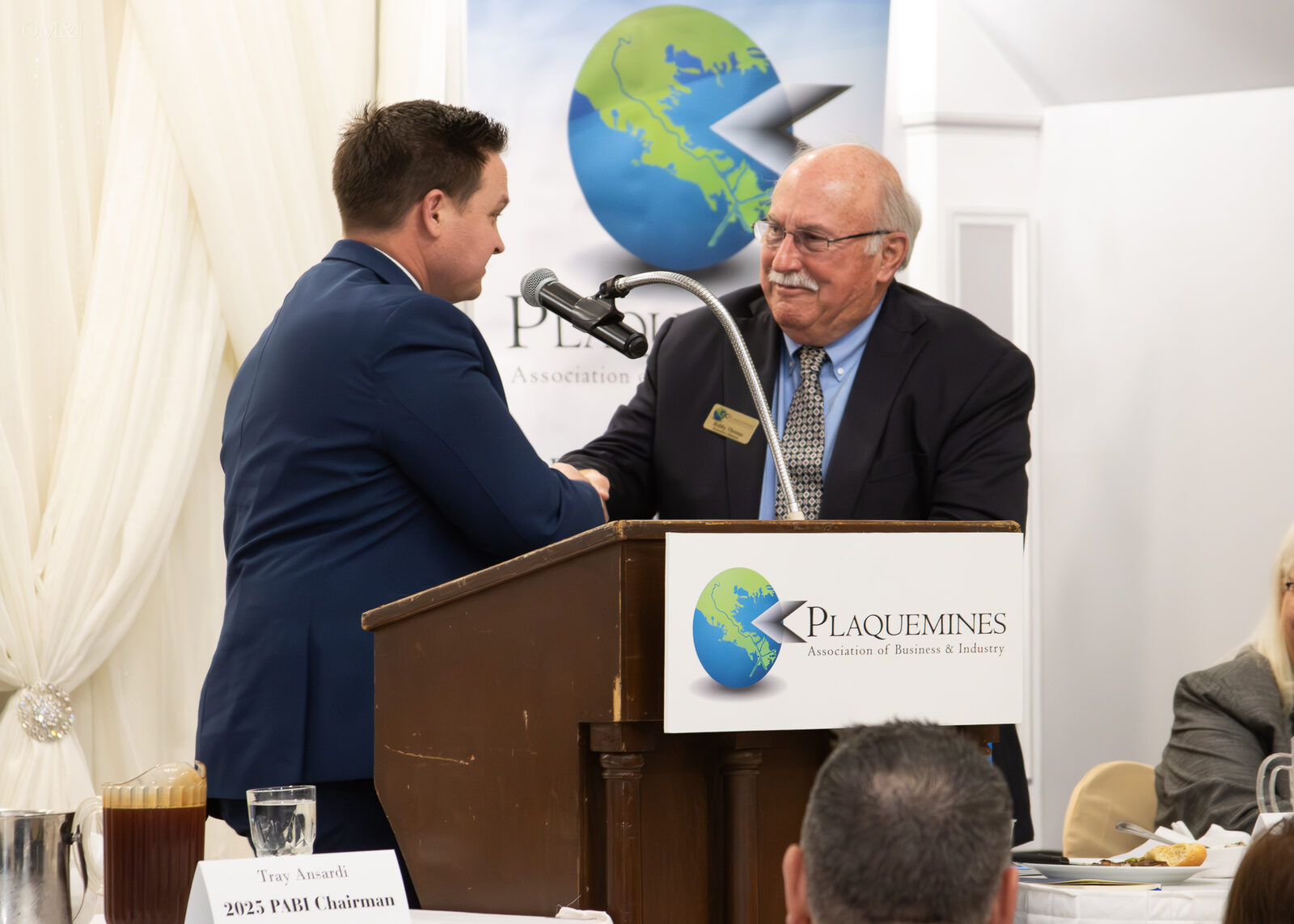 Business leaders greeting one another during a Plaquemines industry luncheon