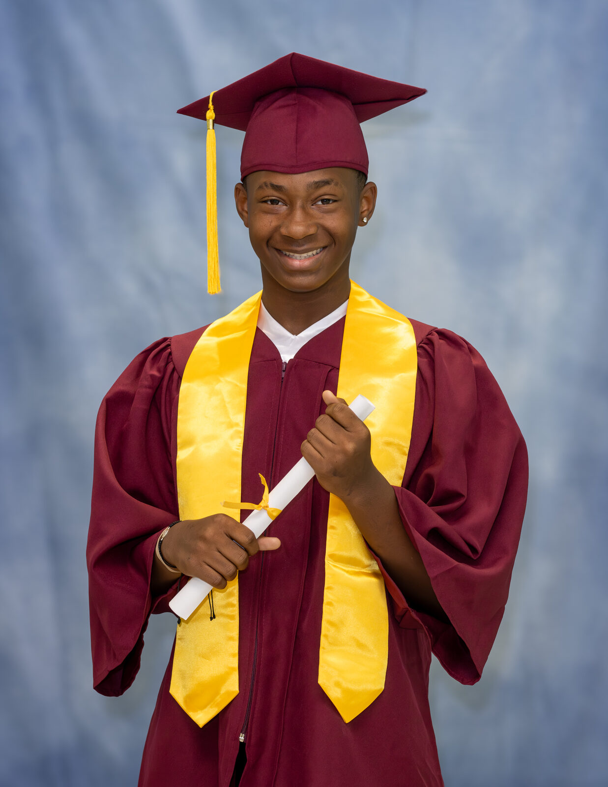 A classic cap-and-gown school portrait