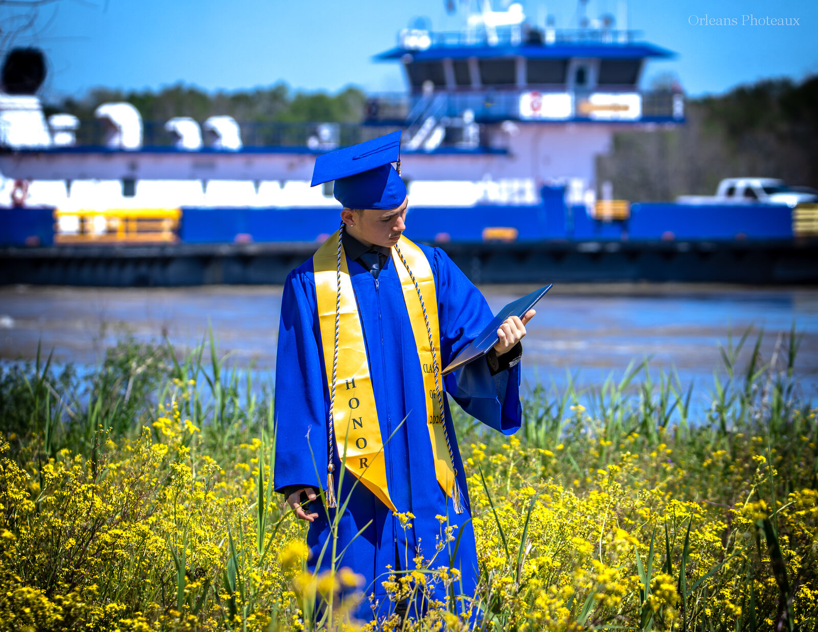 A graduating senior photographed near the Mississippi River